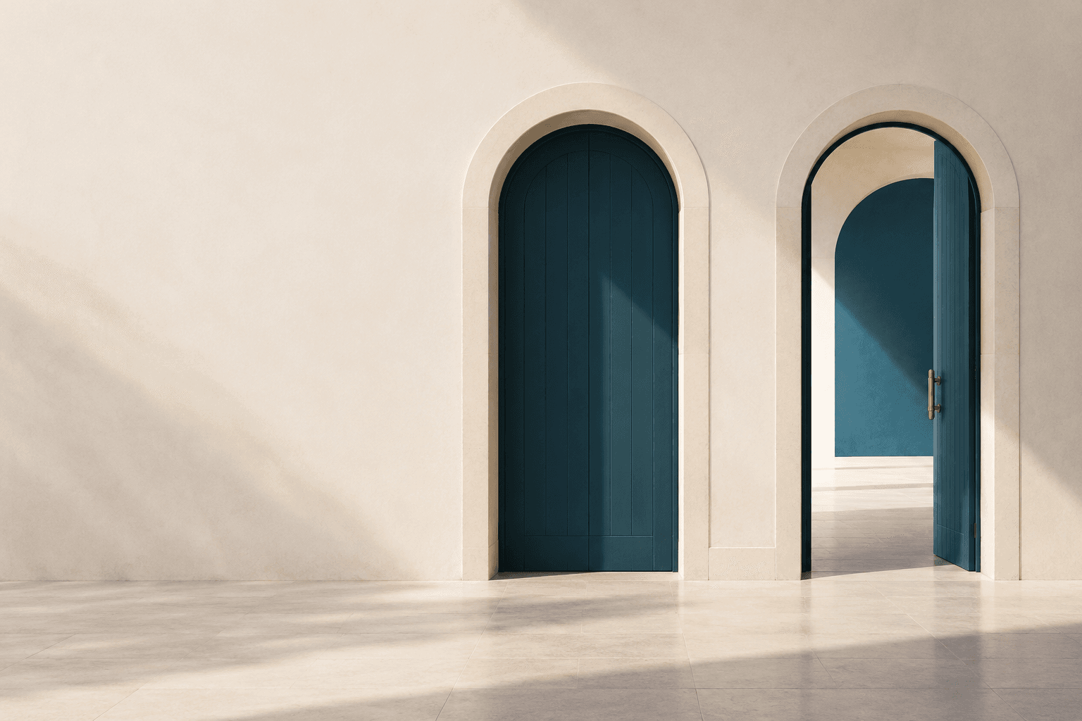 Two matching arched doorways, one open to a bright room.